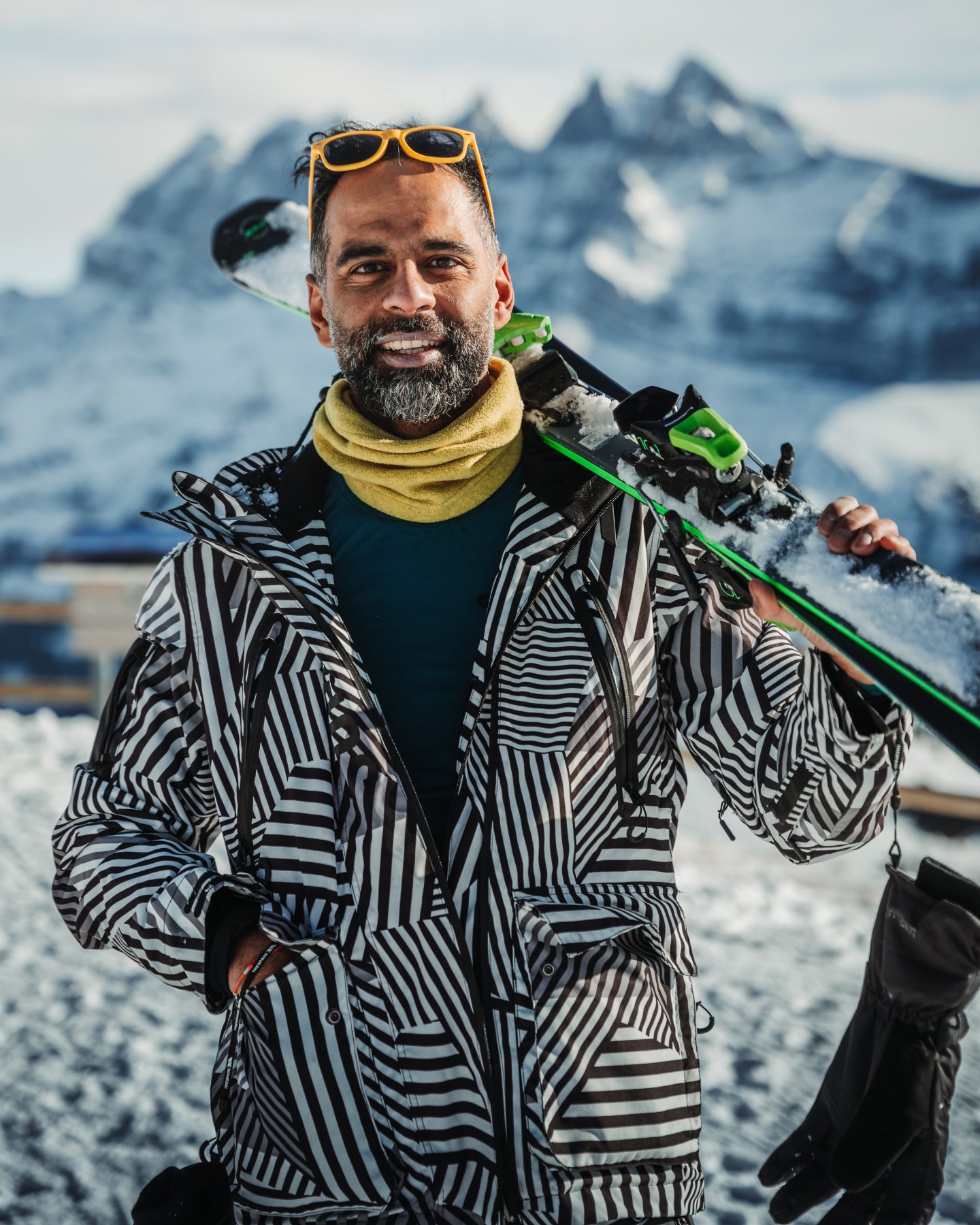 A skier with the mountains behind